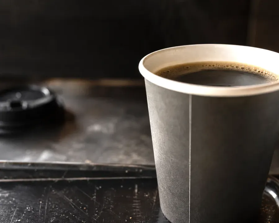 Americano, a finished Rhine Coffee drink photographed on a dark wooden table
