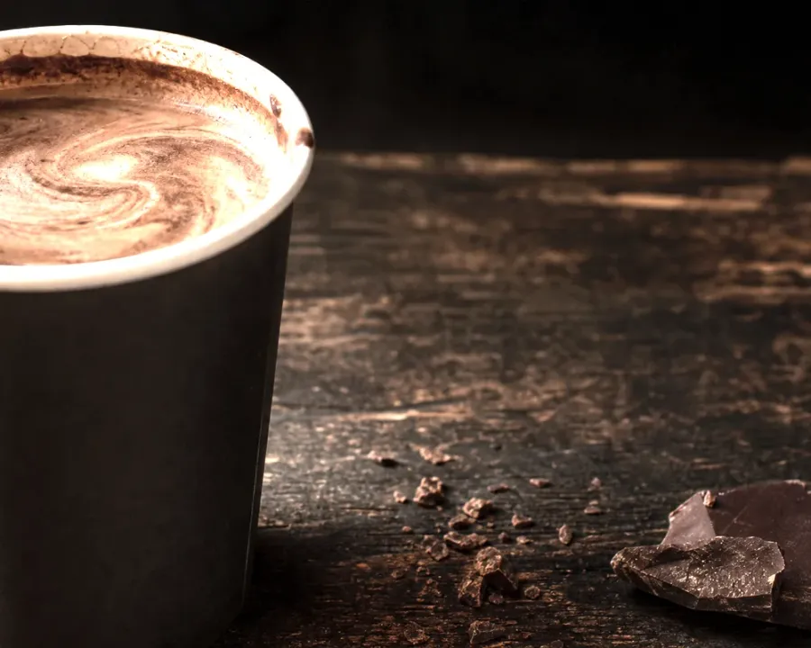Caffè Mocha, a finished Rhine Coffee drink photographed on a dark wooden table